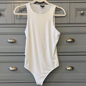 Express White Bodysuit with thong back. New condition.